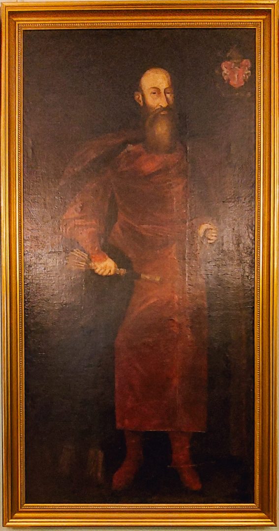 Portrait of Count Walewski above antique furniture inside the manor.