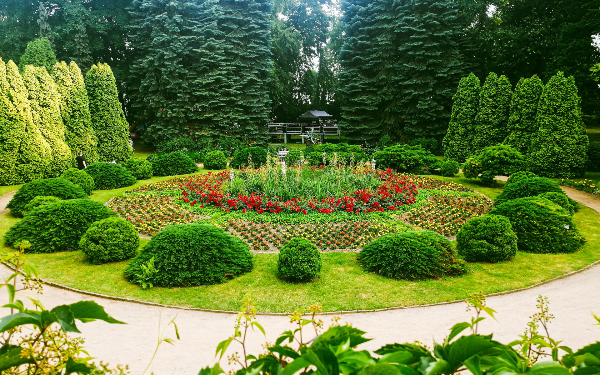 Peaceful park path behind Walewski Manor in Tubądzin, surrounded by old trees and benches