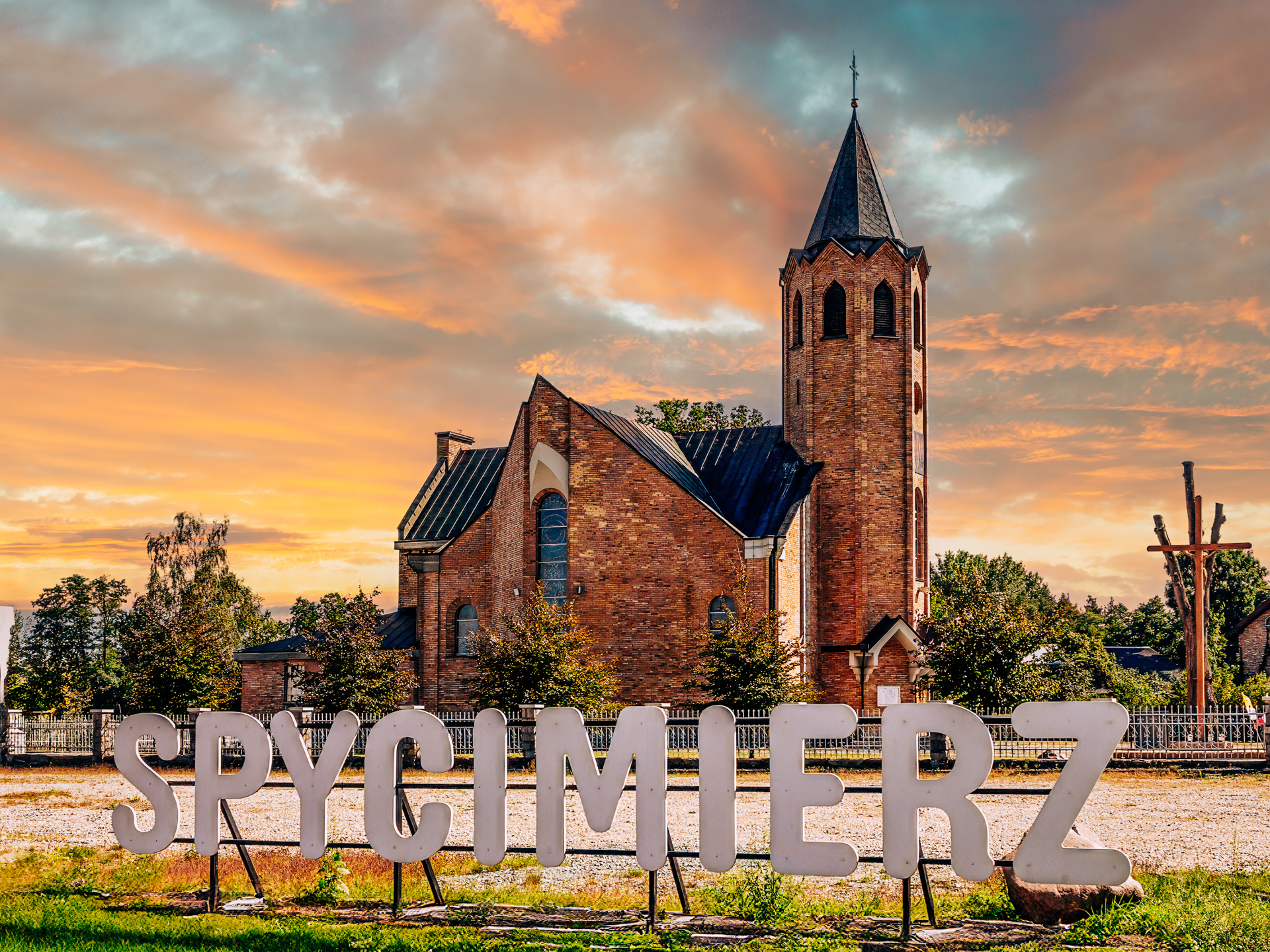 Church in Spycimierz at sunset with welcome sign