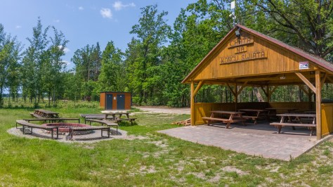 Cyclist-friendly wooden shelter with picnic benches and a barbecue area at Koniec Swiata in central Poland
