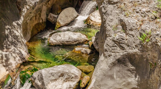 Mossy boulders and clear emerald pools in Sapadere Canyon