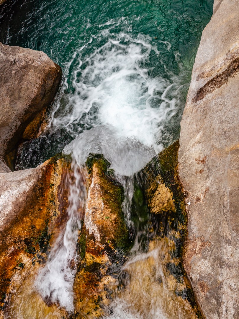 Waterfall spilling into a vivid turquoise pool in Sapadere Canyon, Turkey