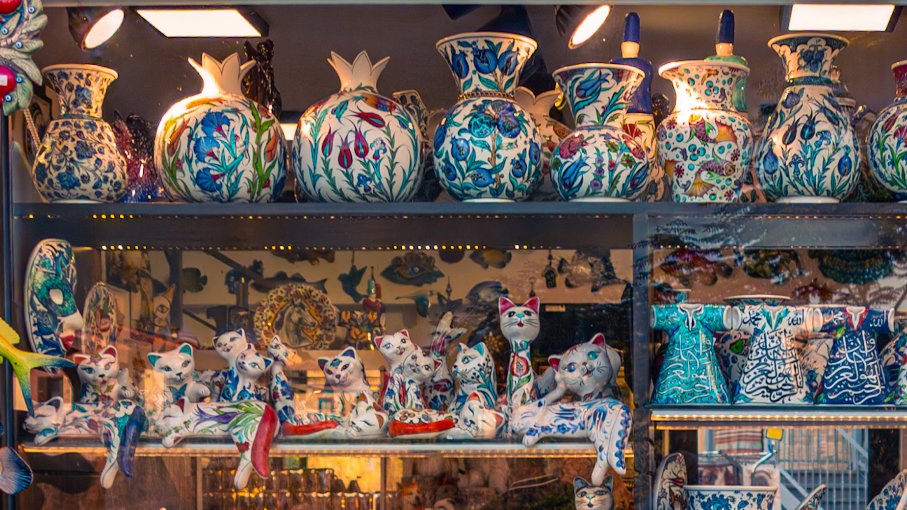 Upper part of a ceramic shop window showing pottery and ornaments with reflections removed for clearer detail