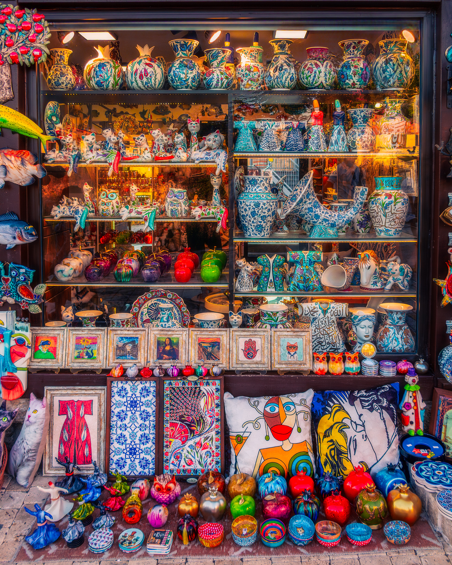 Colorful ceramic shop window filled with pottery, fabrics, and ornaments, edited with enhanced colors and a dreamy glow