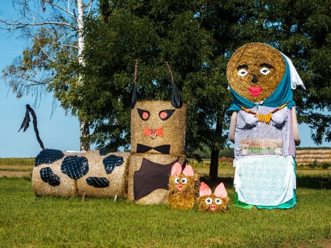 Hay bale nativity-style scene with sheep and figures at Polish festival