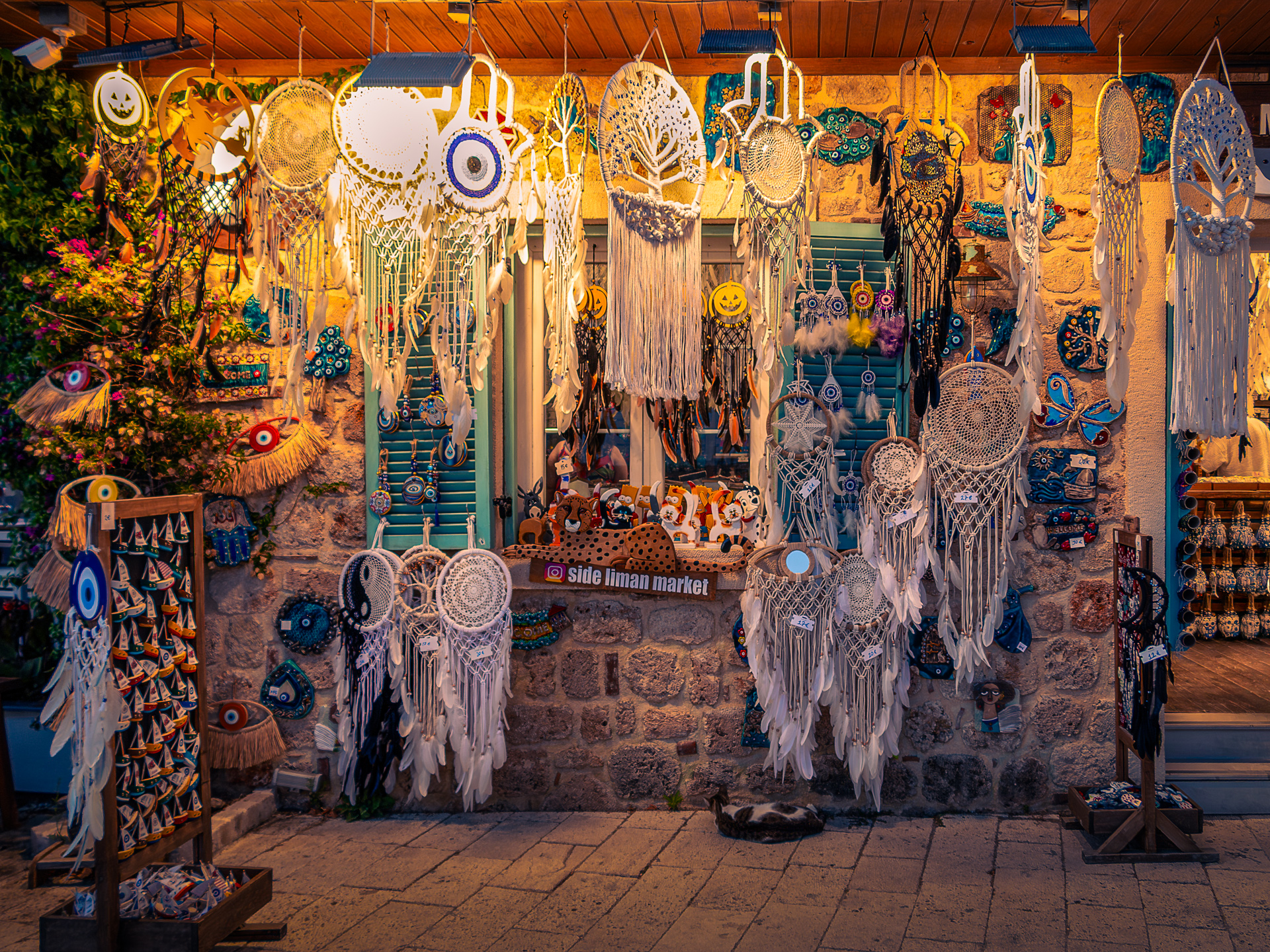 Craft shop in Turkey with dreamcatchers, charms, and handmade souvenirs lit by warm evening light