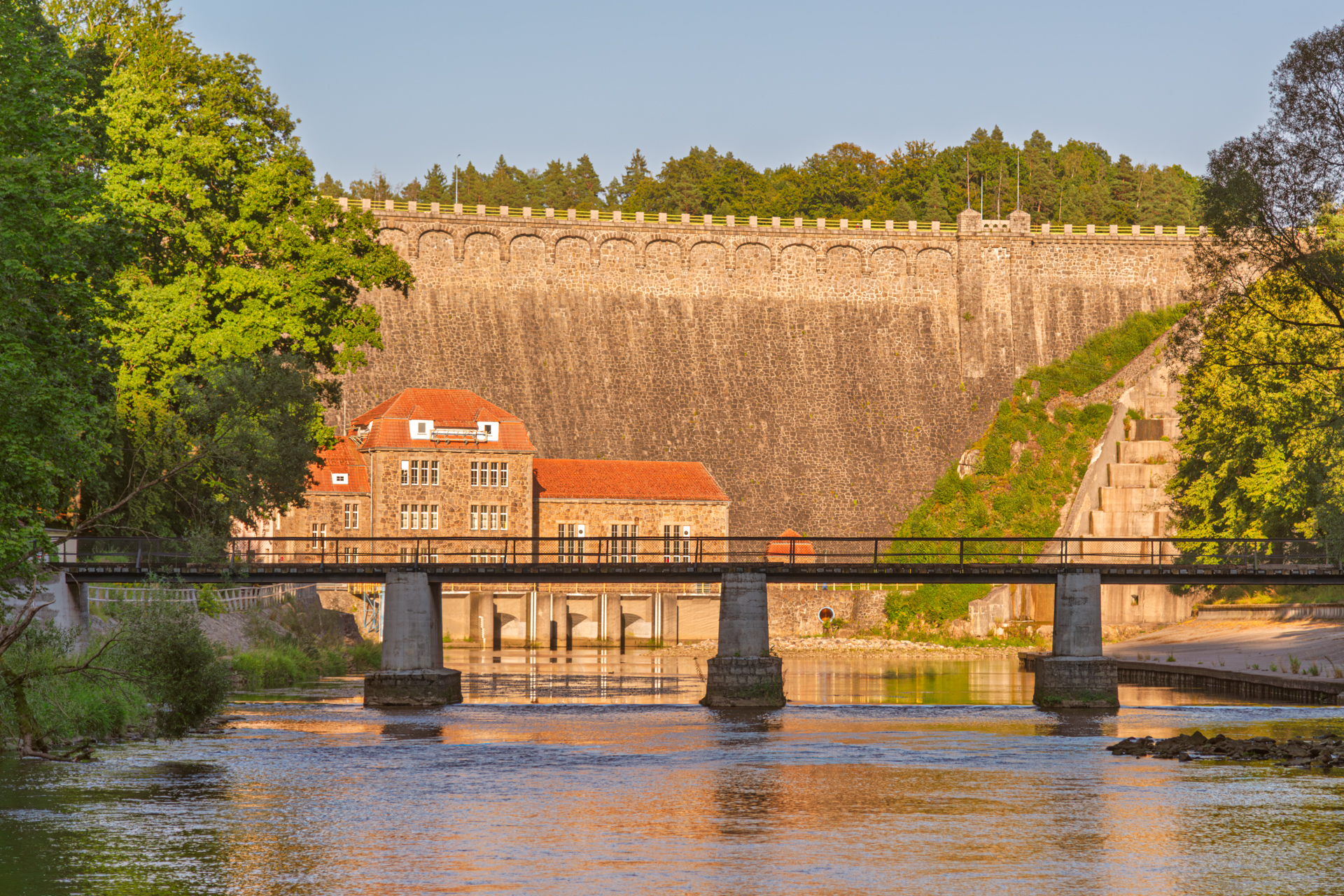 Historic dam on the Bóbr River in the Land of Extinct Volcanoes, Poland, photographed with the bridge in the foreground and edited in Photoshop to enhance light and reflections