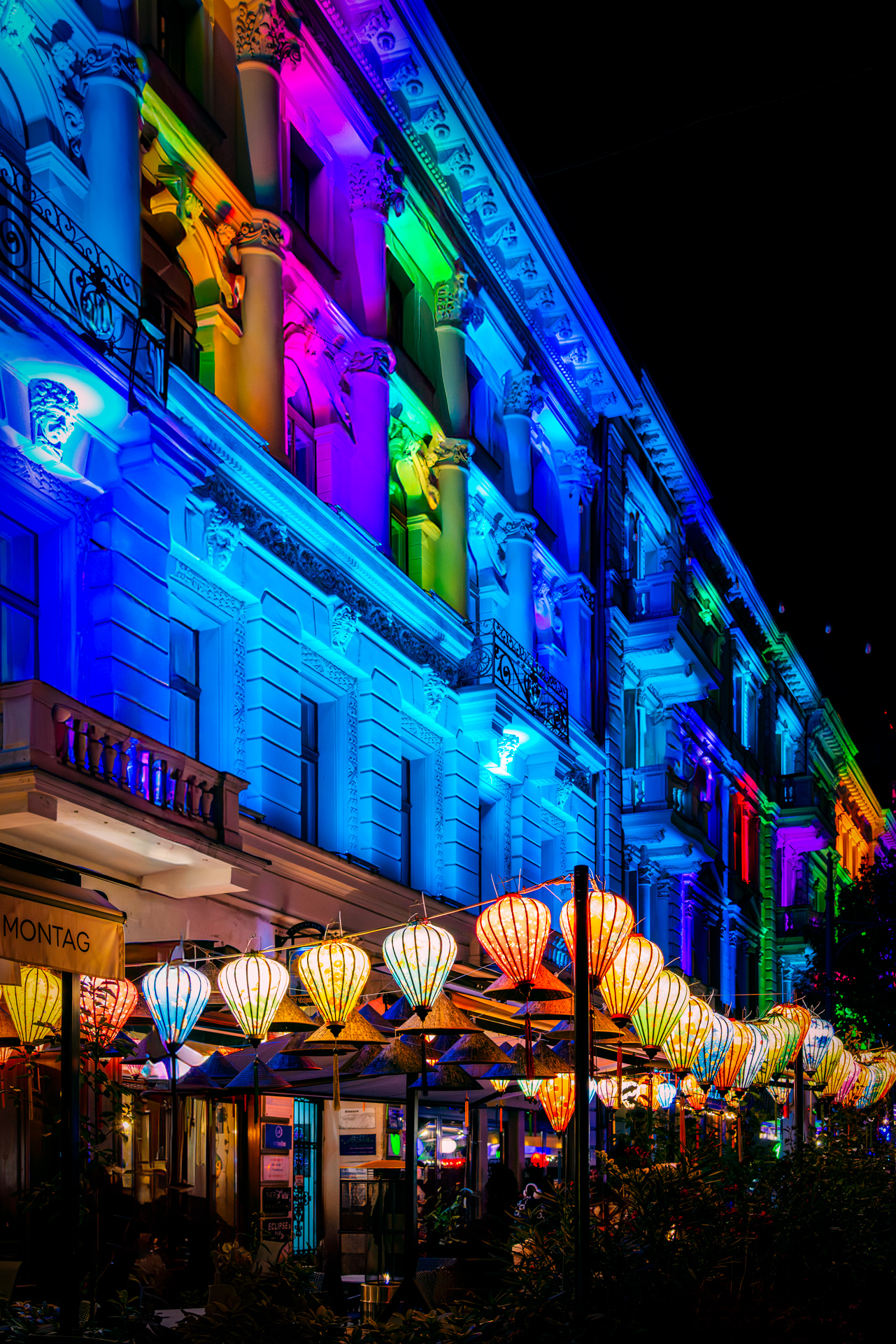 Colorful hanging lanterns illuminating Piotrkowska Street in Łódź during Light Move Festival 2025