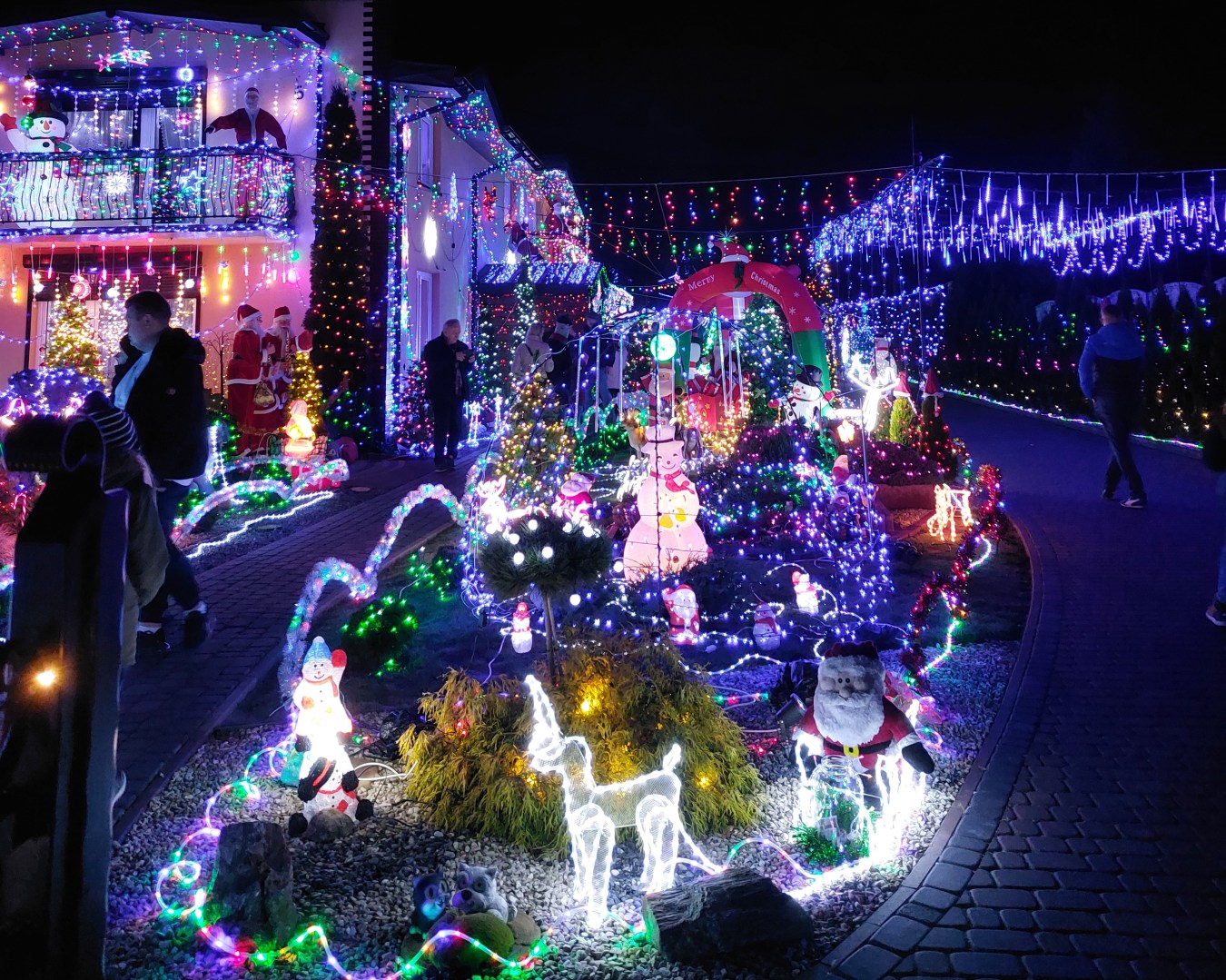 Entrance gate of Polish Las Vegas with hanging lights and an illuminated island visible inside
