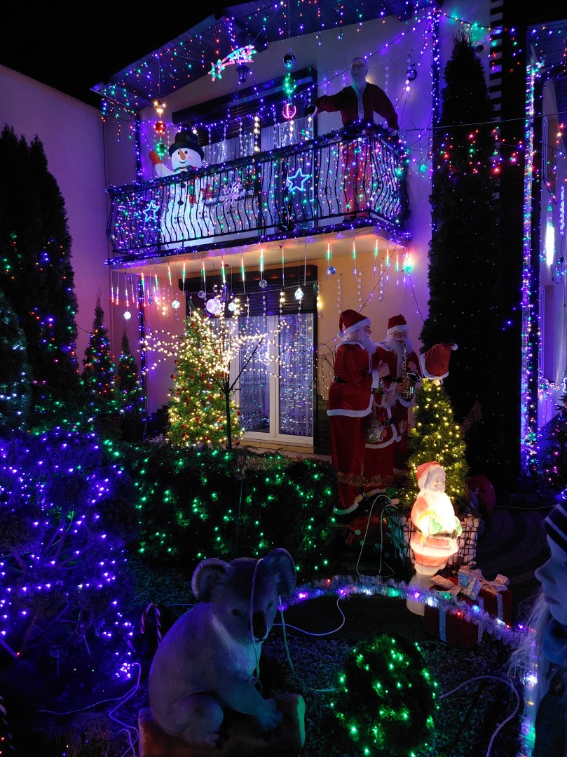 Wall and balcony of the owners’ house fully illuminated with Christmas lights