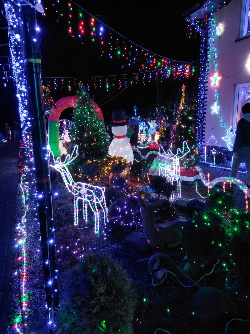 Another angle of the illuminated island with dense Christmas lights at Polish Las Vegas