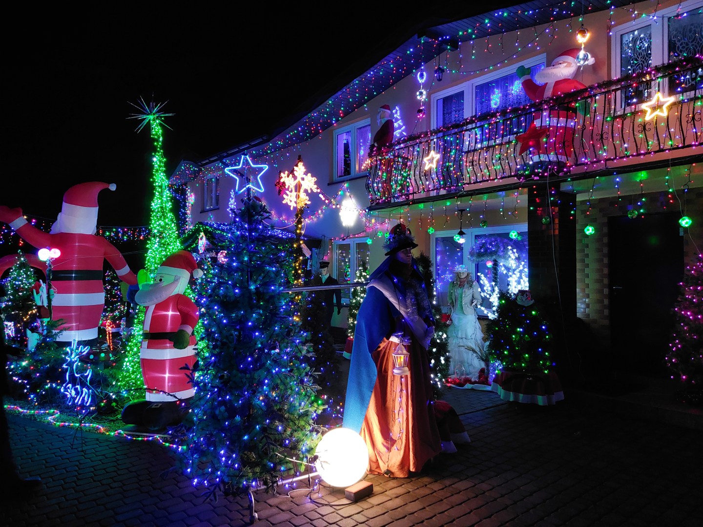 Decorative Christmas figure with the illuminated house of the owners in the background
